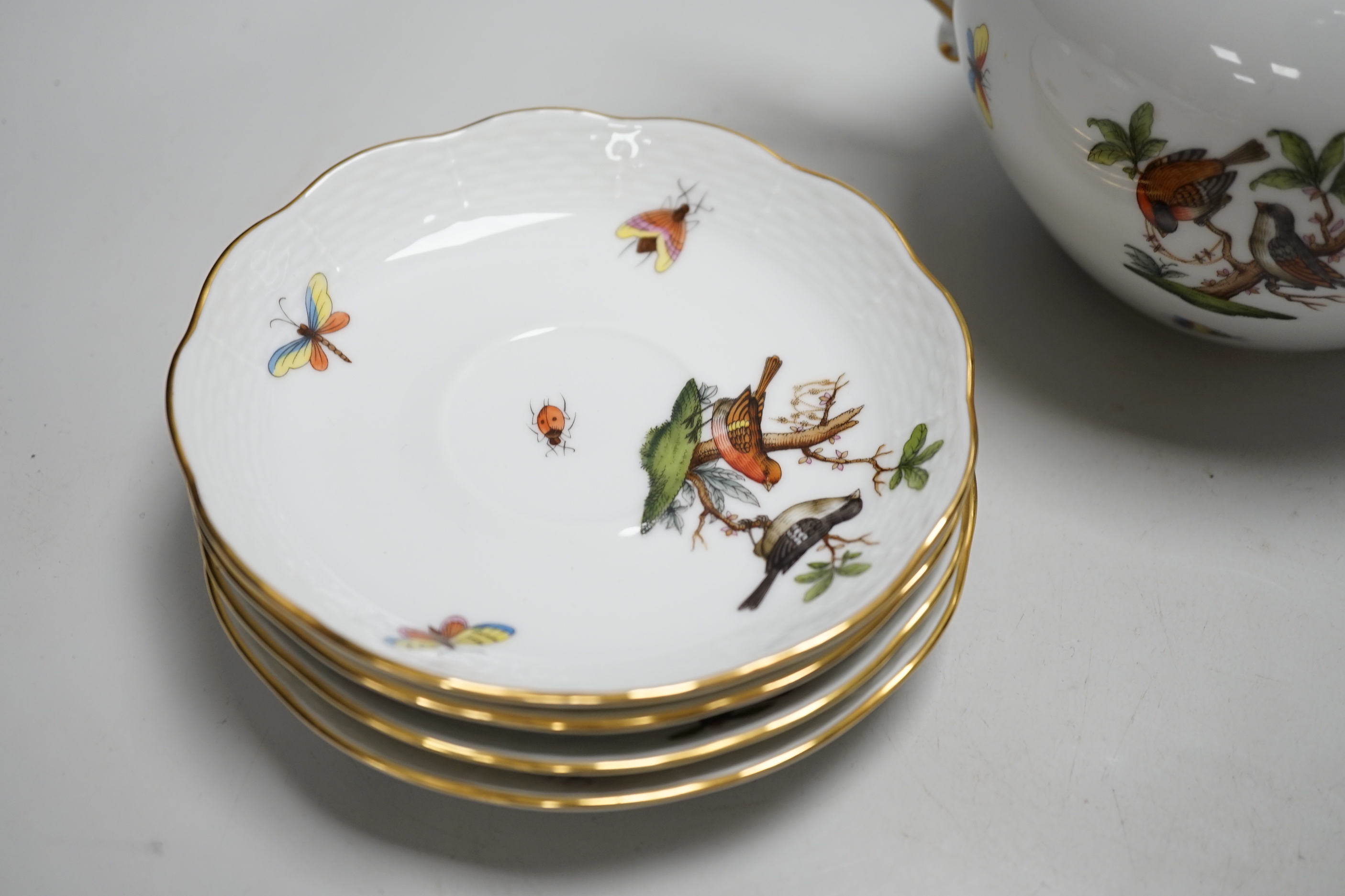 A Herend handpainted pot and cover, a cup and four saucers and teapot decorated with birds and insects and a similar sucrier and cover decorated with fruit